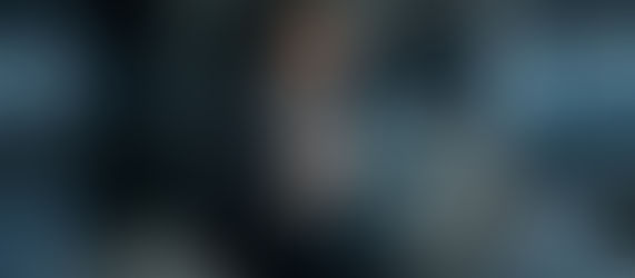 Executive holding a glowing liposomal NAD+ capsule, with a holographic HUD displaying cellular age reversal and mitochondrial biogenesis.