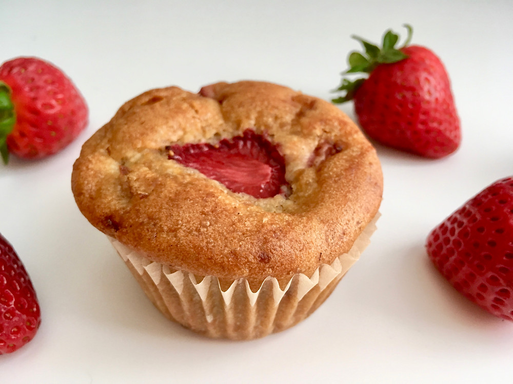 close up of single strawberry rhubarb muffin