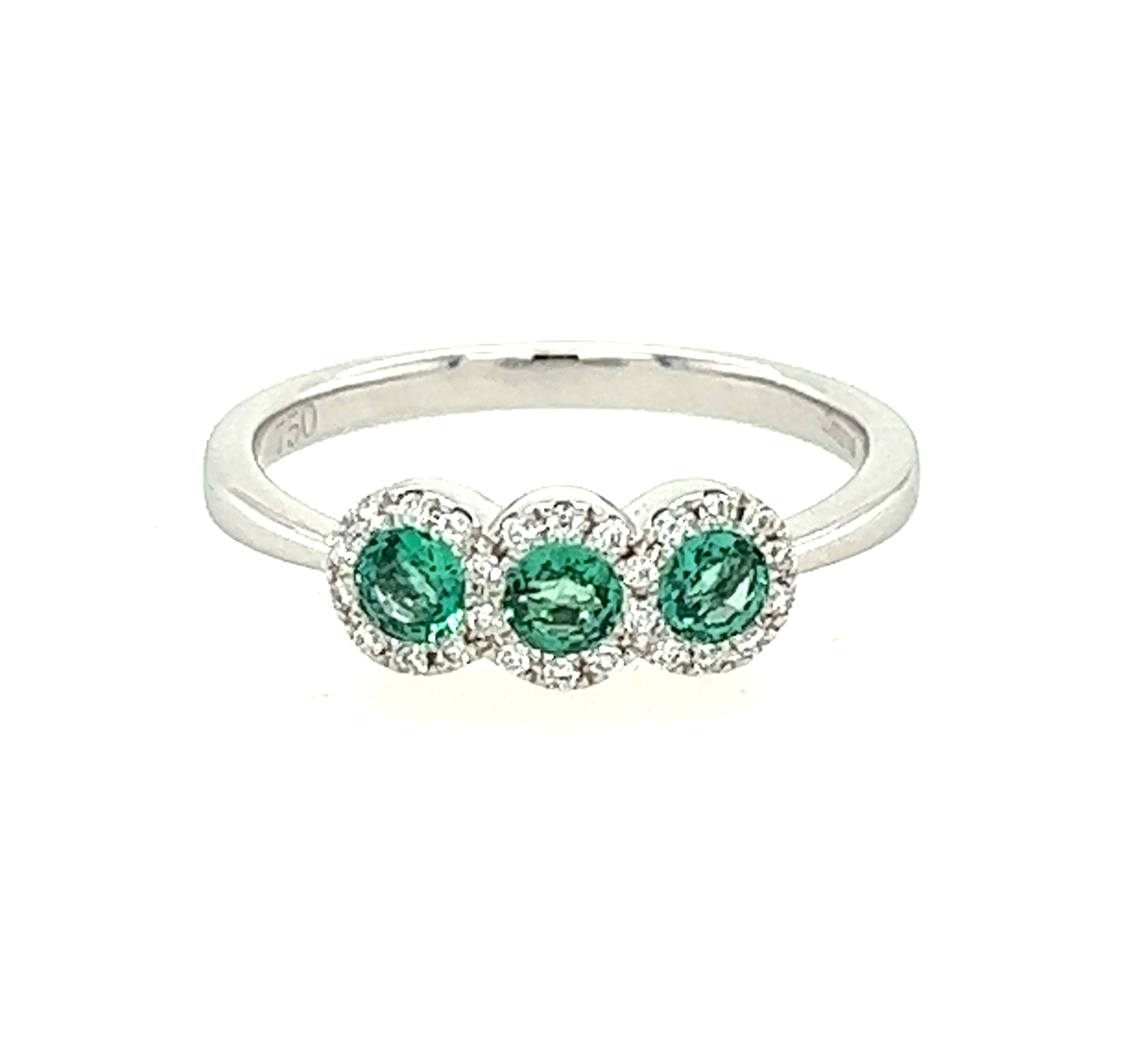 Emerald 0.39ct and Diamond 0.10ct Three Stone Halo 18ct White Gold Ring