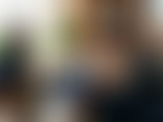 A professional therapist in a modern, warm office setting in Marietta, Georgia, guiding a couple through a calm, constructive conversation using the Gottman Method.