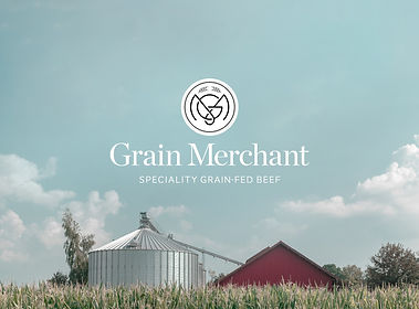 Agricultural landscape with a grain storage silo & a red barn under a blue sky, featuring the "Grain Merchant" logo above