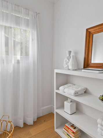 magnolia cottage bathroom with lots of linens and toiletries