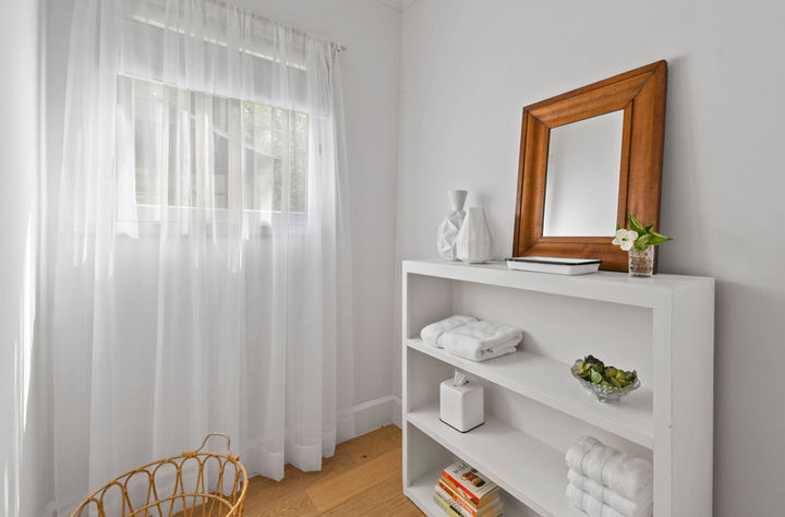 magnolia cottage bathroom with lots of linens and toiletries