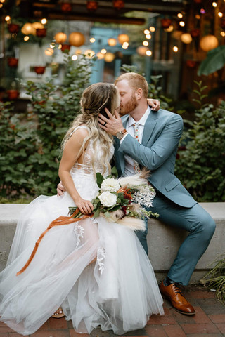 Husband and wife kissing on their wedding day