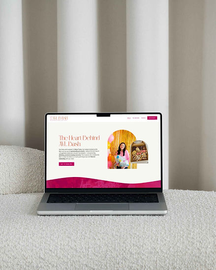 laptop sitting on a cream colored couch in front of beige curtains, open to the avl bash website