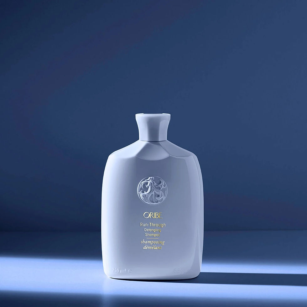 Sleek 250 ml bottle of Oribe Run‑Through Detangling Shampoo in pale blue packaging