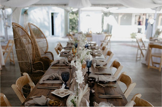 Wedding reception farmhouse style table with wooden chairs