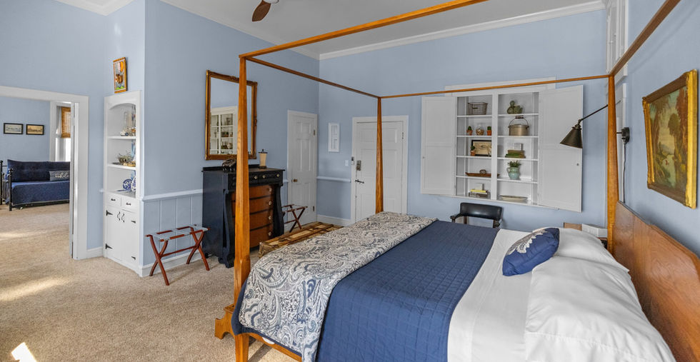 Charming king suite with seating area in The Christie at The Inns at 8th and Main – perfect for romantic escapes or small family stays.