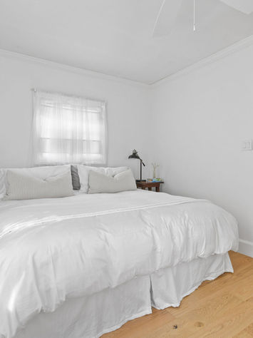 magnolia house king sized bedroom with white linens