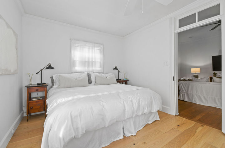 magnolia house king sized bedroom with white linens