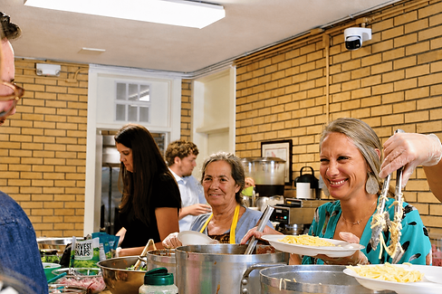 church members serving a meal in the fellowship hall