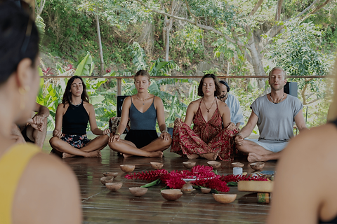 pessoas meditando, sentadas, praticando yoga.png