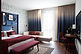 Hotel Indigo East Side Gallery is a useful alternative if you’d rather experience Berlin’s eastern neighbourhoods than base the whole trip around Schöneberg. It sits directly beside the East Side Gallery and Oberbaumbrücke, with Friedrichshain and Kreuzberg’s restaurants, bars and clubs spreading out on either side of the river.
Rooms are contemporary and colourful, with free Wi-Fi, air-conditioning and design touches inspired by the surrounding neighbourhood. There’s a fitness room and restaurant, but the real highlight is the rooftop Gallery Rooftop Bar, with excellent views across the Spree and Berlin skyline.
Warschauer Straße station is around ten minutes away, giving you quick S-Bahn and U-Bahn connections towards Alexanderplatz, Mitte and western Berlin.
This isn’t the place to stay if you want Schöneberg’s gay bars outside the door, but it makes much more sense if your Berlin plans lean towards Friedrichshain, Kreuzberg and the city’s more alternative nightlife.
GayMapper tip: a good counterpoint to the Schöneberg-heavy choices — especially for repeat visitors who want to see a different side of Berlin.