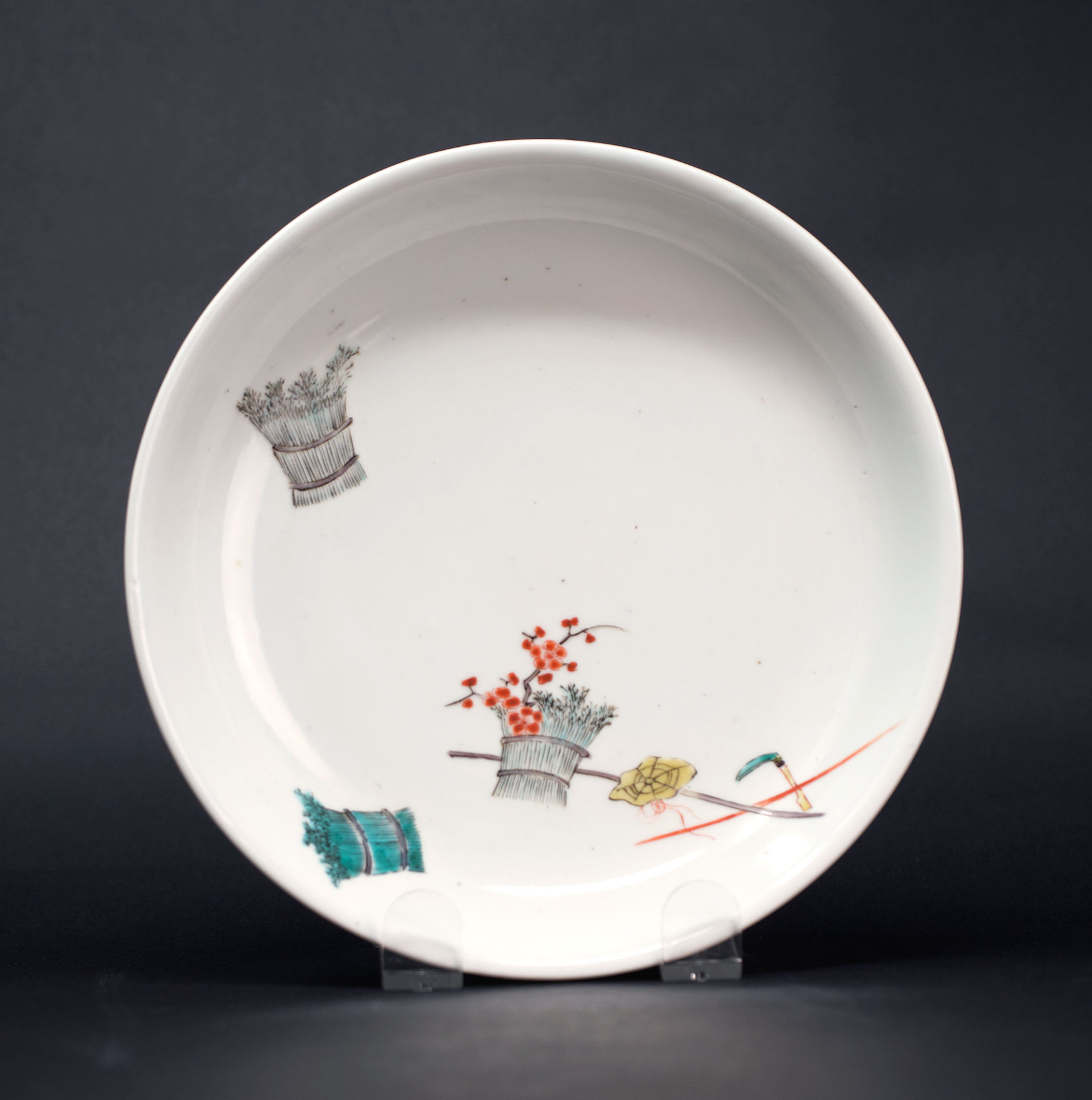 A sublime Kakiemon dish enamelled with 'Shiba-taba Kama-kasa', Arita c1680-1700