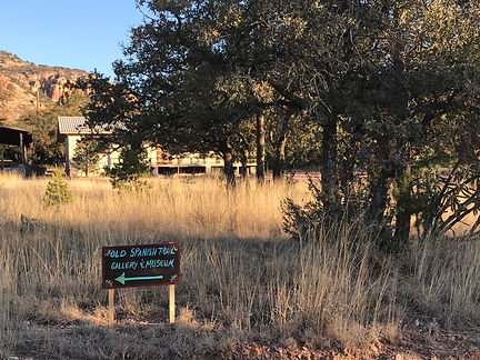old spanish trail gallery and museum sign and studio in trees at crows nest ranch ft davis