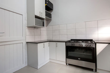 Folkstone grey melamine kitchen with rustenburg granite worktop and a free standing gas stove