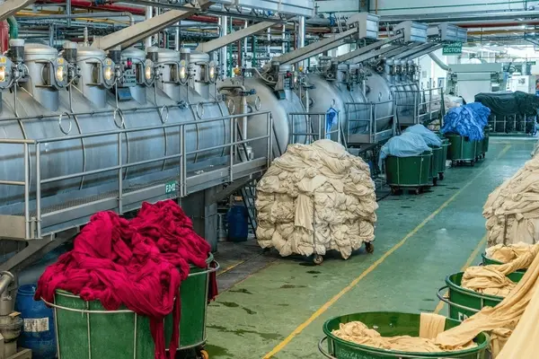 Textile factory with dyeing machines and various colored fabrics, Eastern Engineers.