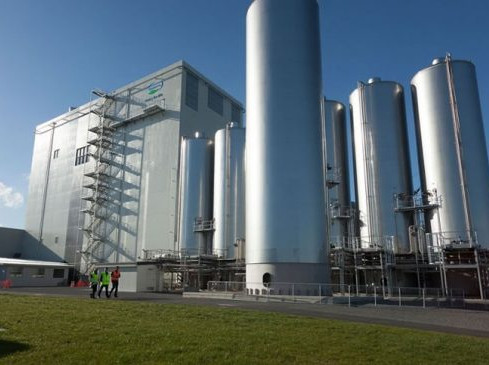 Large industrial plant with tall silver tanks and clear skies. Eastern Engineers