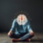 Illustration of brain and calm person practicing mindfulness to manage anxiety.