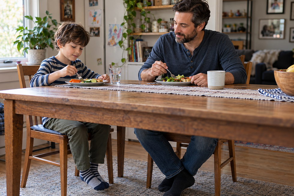 Father and child eating lunch together at a home dining table.