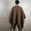 Thumbnail: Warm poncho made of camel yarn with trim made of genuine soft leather