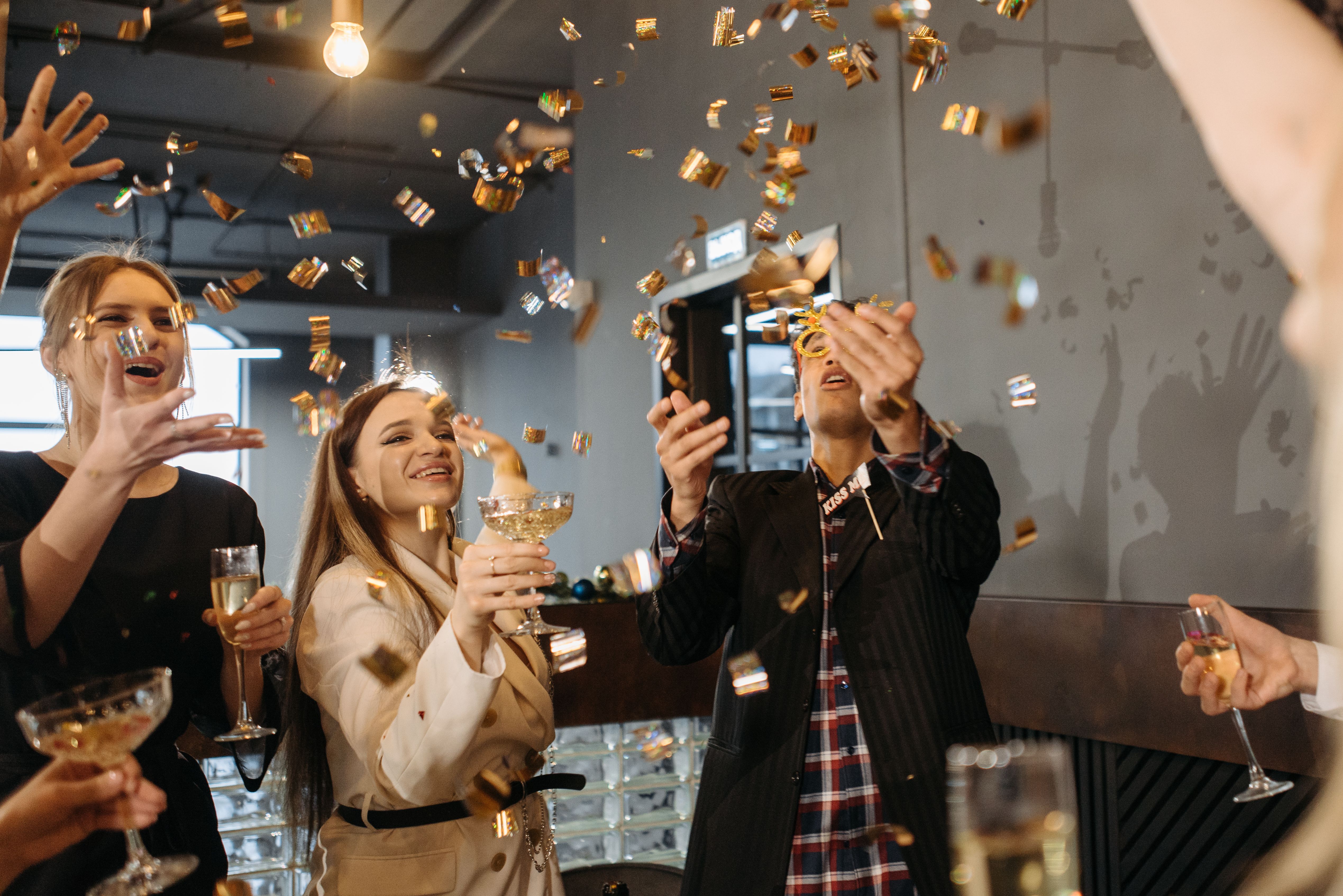 Collaborateurs célébrant le Nouvel An lors d'une soirée d'entreprise avec confettis et champagne