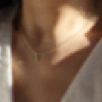 MODEL WEARS 9CT GOLD FLORAL BIRTH MONTH NECKLACE