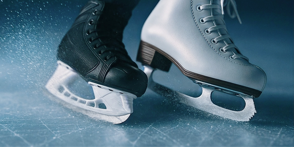 hockey skate and figure skat stopping and spraying ice into the air.