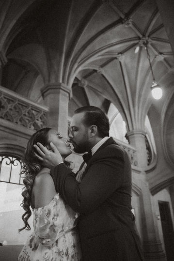 Maria and Chris standing near Gothic Revival hallways of U of T.