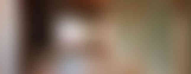 The photo shows a traditional Japanese-style room with tatami mats on the floor. The room features wooden walls and ceiling, sliding paper doors (shoji), and a low table in the center. The room has a calm and serene atmosphere.