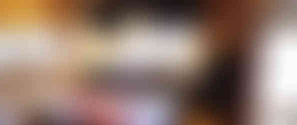 A kitchen with a wooden table and four chairs.