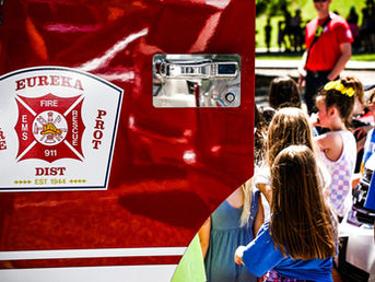 Children surrounding a Eureka Fire Protection District Fire Truck