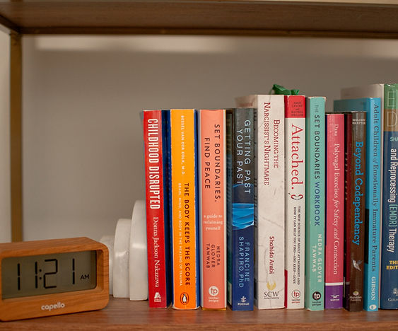 therapy books on shelf with digital clock