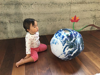 My daughter looking at a model of Mother Earth.