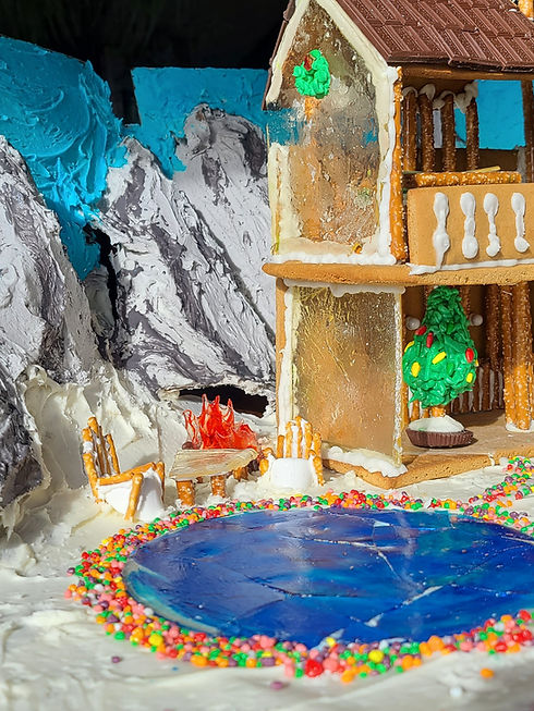 Gingerbread lake house with sugar glass and pretzel chairs and fire