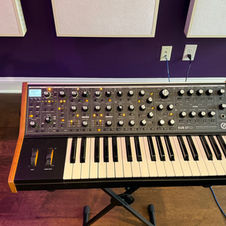 Moog Sub37 Bob Moog Tribute synthesizer with wooden frame and extensive control knobs on a stand