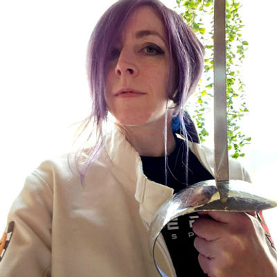 Photo of Kat Laurange holding a sword