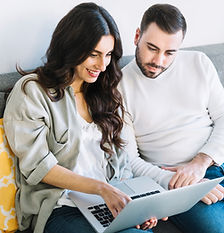 couple-using-laptop-sofa.jpg