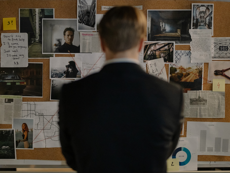 Police officer looking at an investigation board