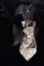 Necktie on black mannequin and earring, detail shot, fashion and style.