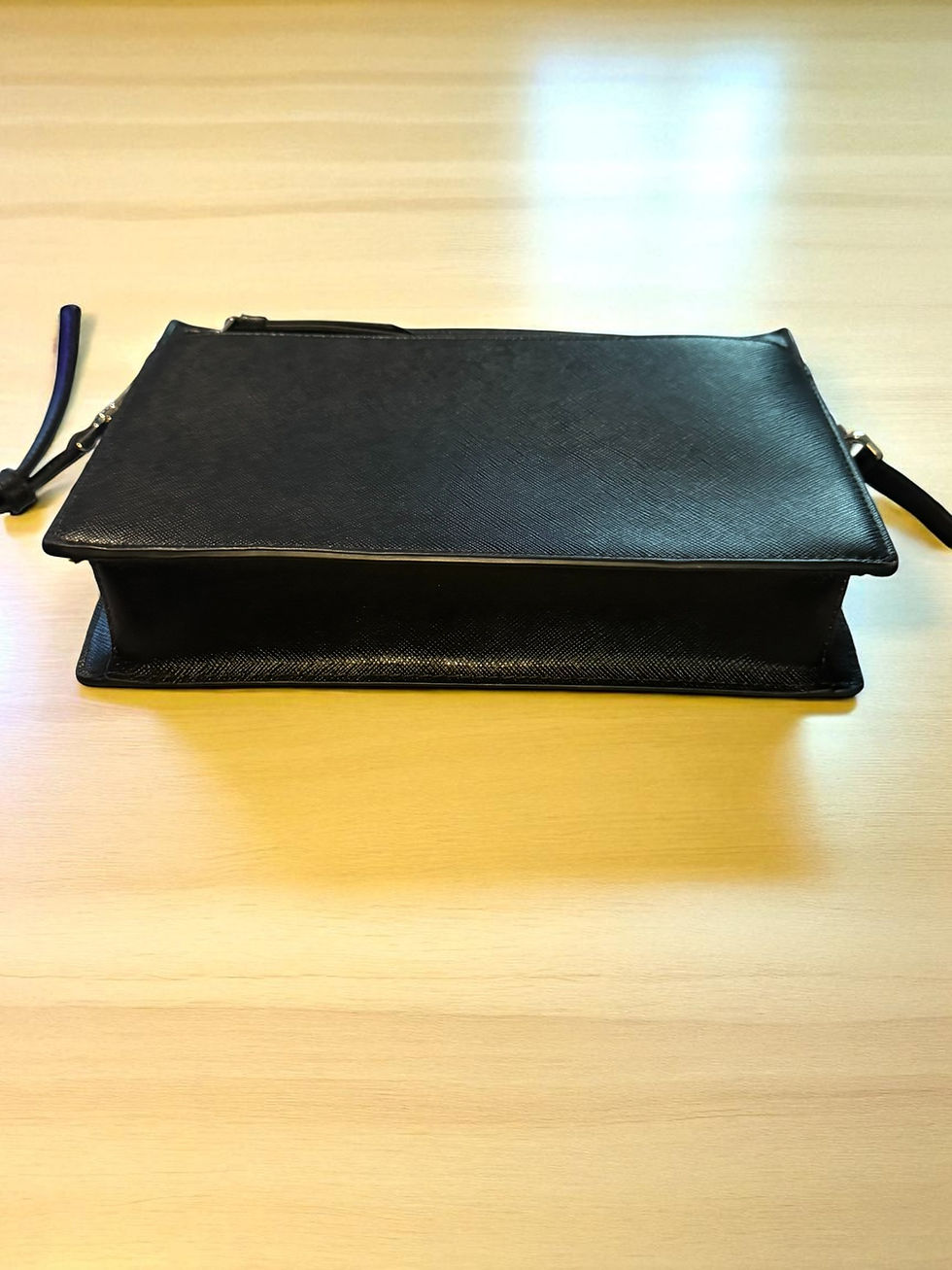 Thumbnail: Black Fossil Snap Closure Wallet on a light surface, minimalistic design.
