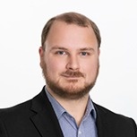 Portrait of a male associate in a suit and blue shirt