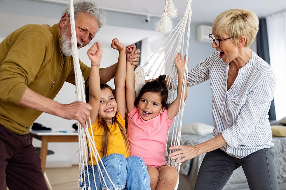 Grandparents playing with grandchildren in a hammock