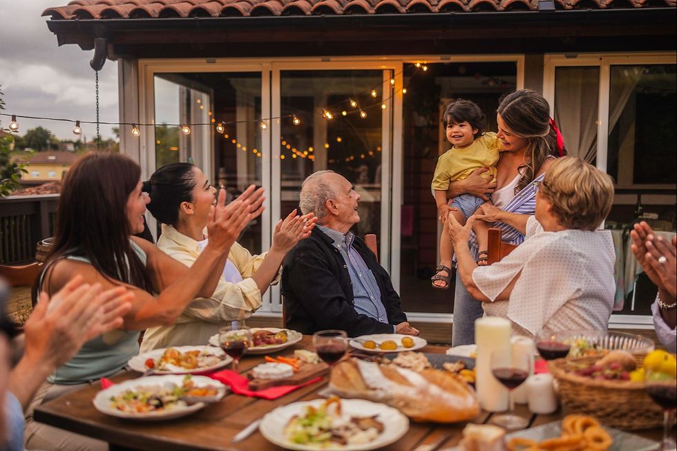 Multi-generational family enjoying an outdoor dinner.