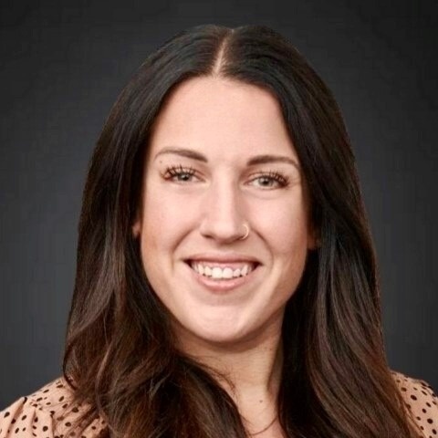 Smiling female associate with long dark brown hair