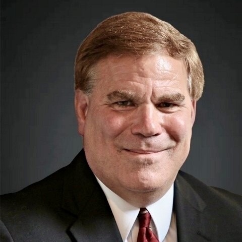Professional headshot of a smiling male associate