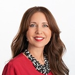 Woman with long brown hair smiling at the camera