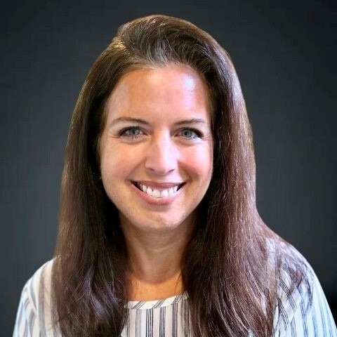 Smiling female associate with long brown hair.
