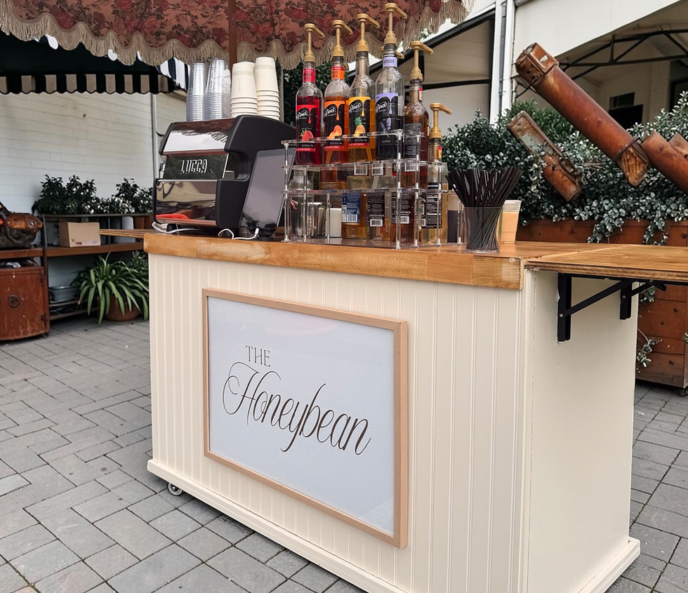 The Honeybean mobile coffee cart with outdoor umbrella.