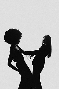 Two women holding hands in silhouette against a white background.